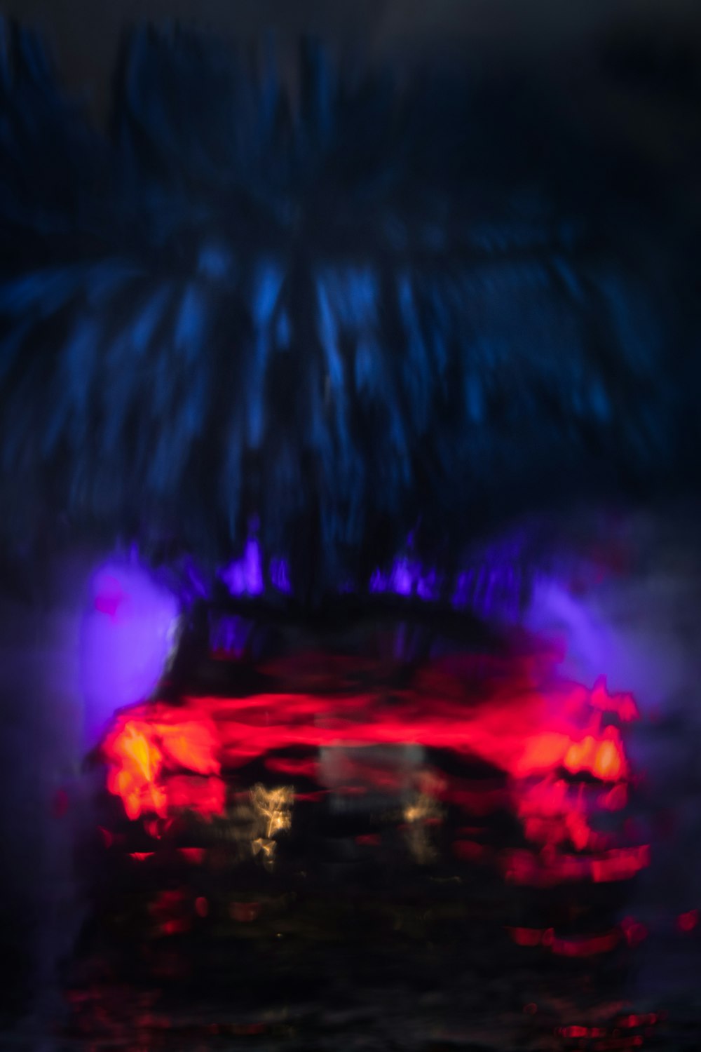 a blurry photo of a car in the rain