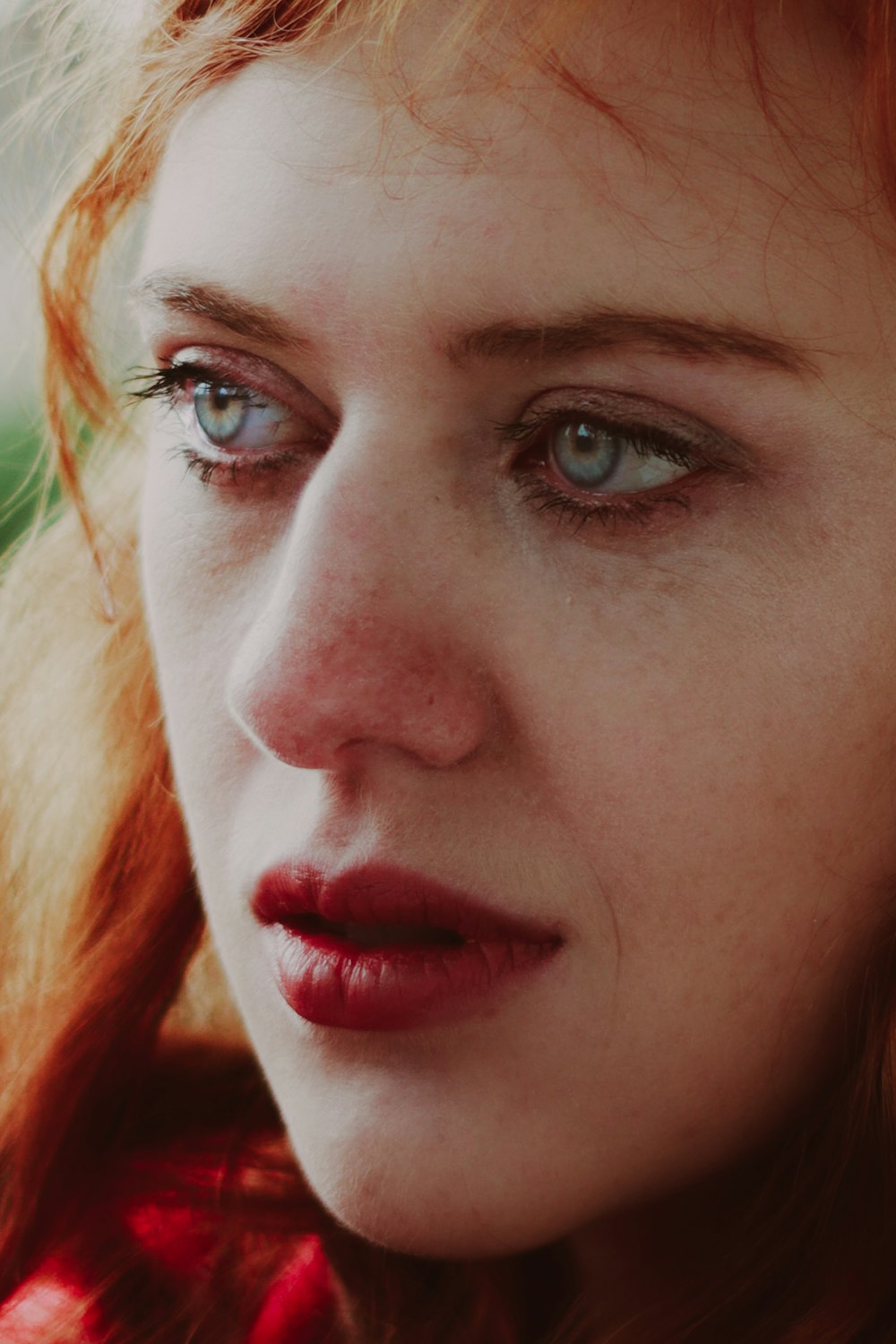 a close up of a woman with blue eyes