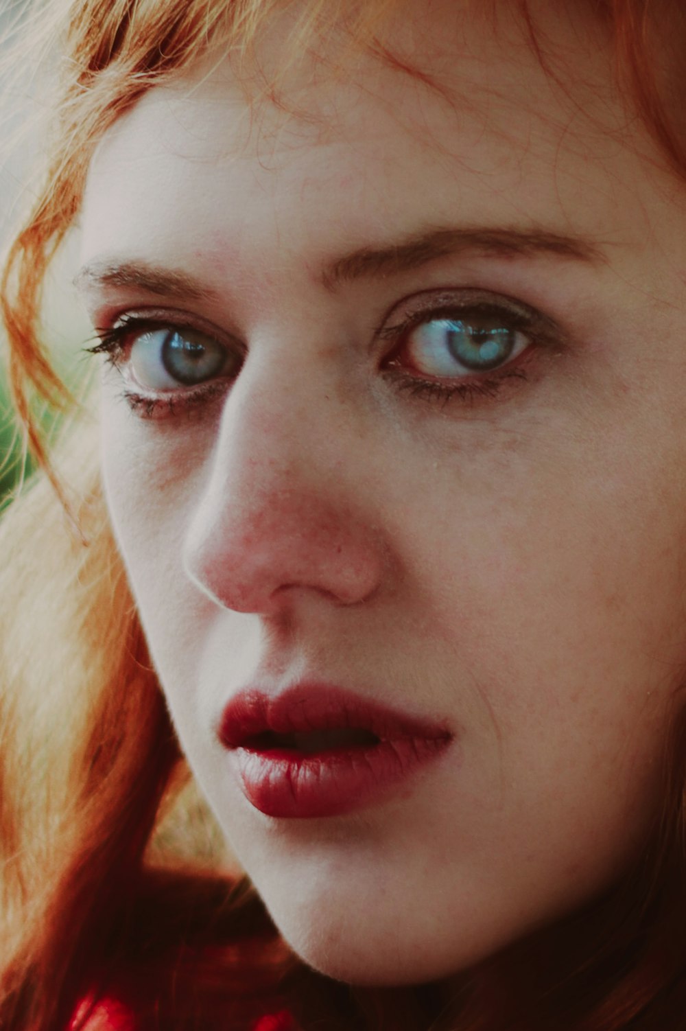 a close up of a woman with blue eyes