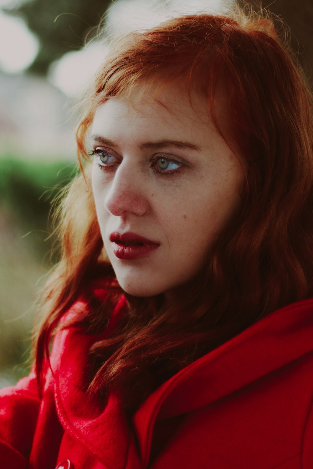 a close up of a person wearing a red jacket
