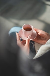 A casual setting with a woman lounging in soft jeans, enjoying a cup of coffee.
