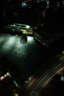 Night view of a well-lit municipal sports field with bright LED lights illuminating the area