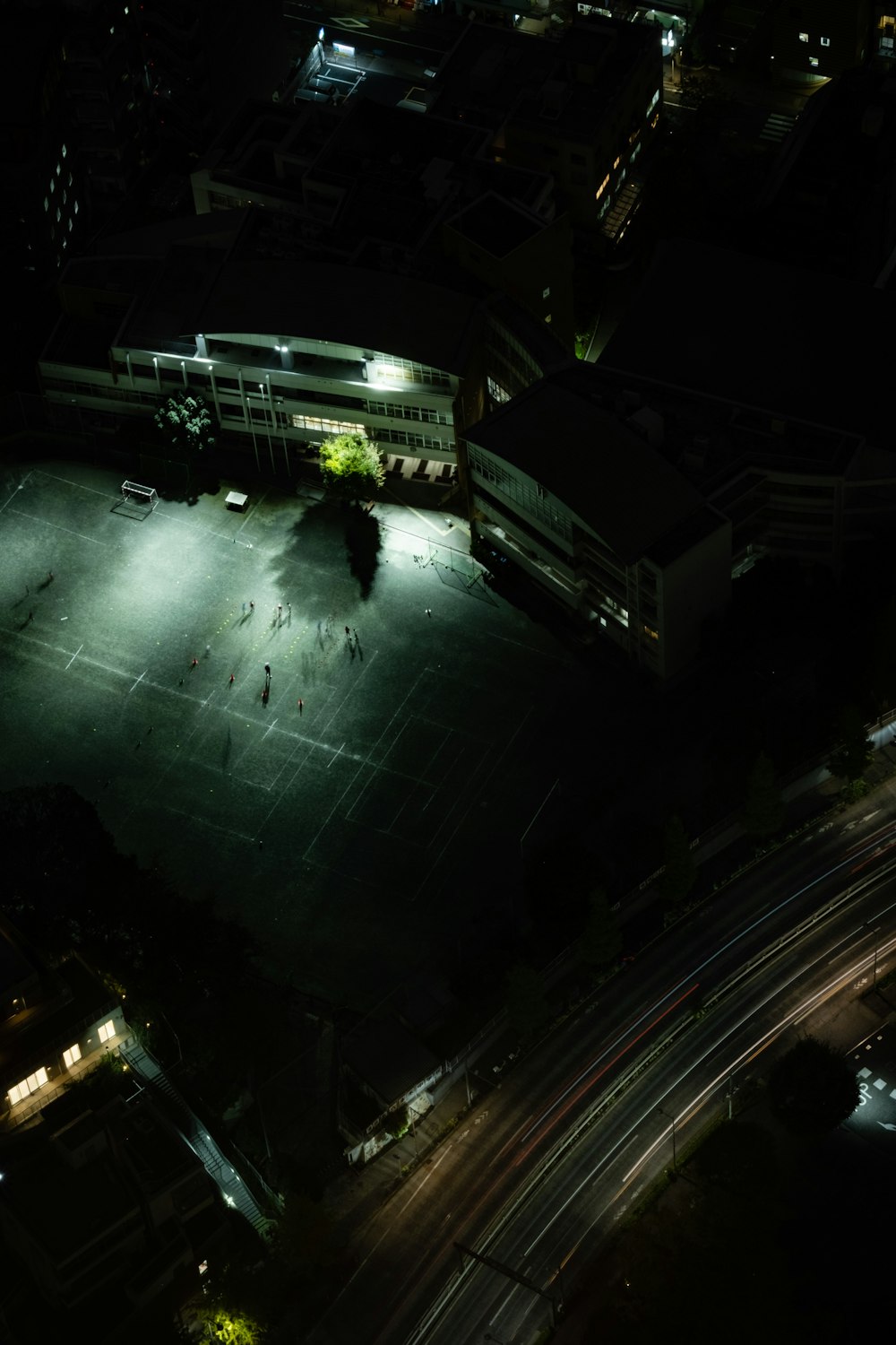an aerial view of a parking lot at night