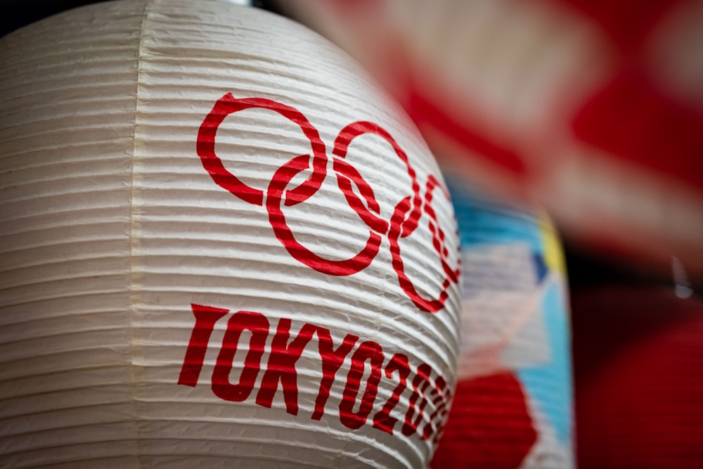 a close up of a paper lantern with the olympic logo on it