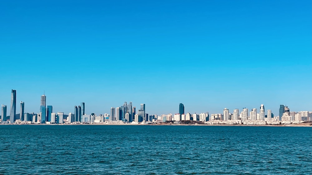 a large body of water with a city in the background