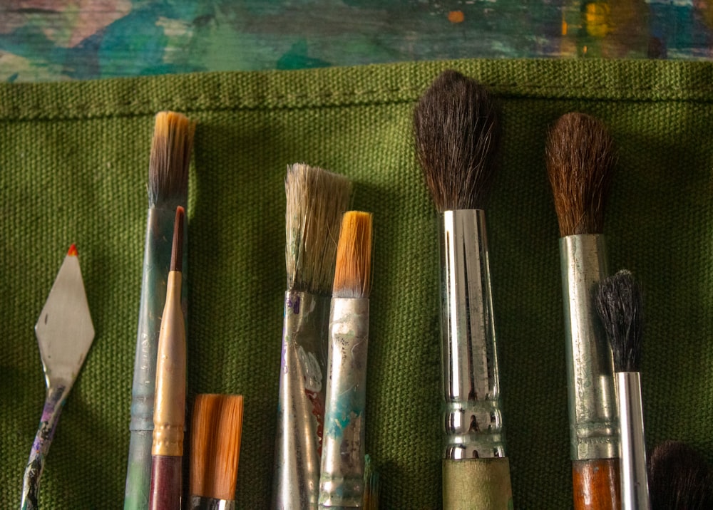 a close up of a bunch of brushes on a cloth