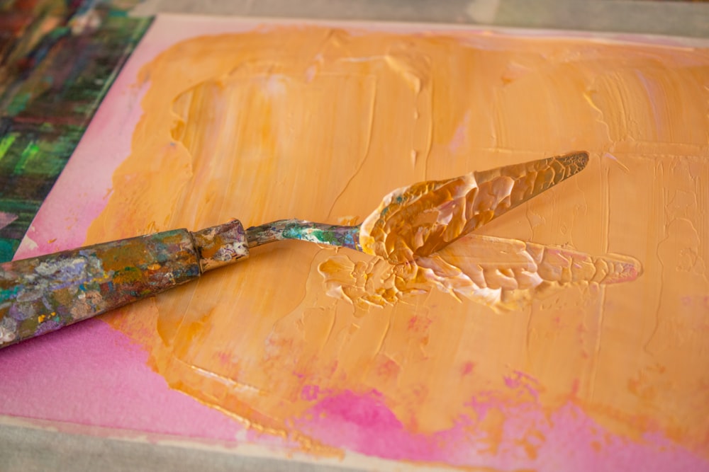 a close up of a paint brush on a piece of paper