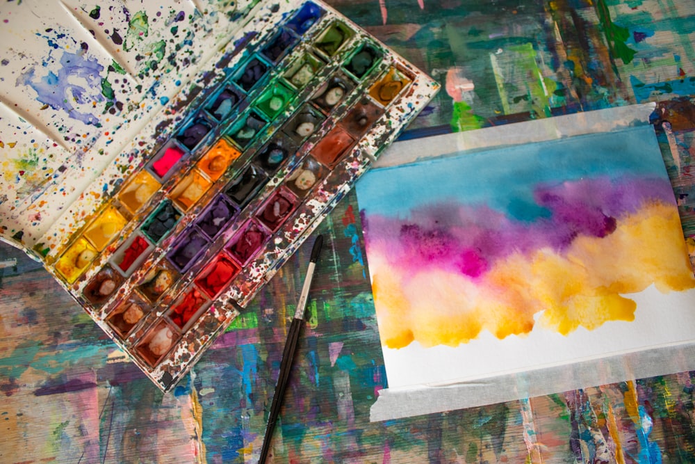 a palette of watercolors sitting on top of a table