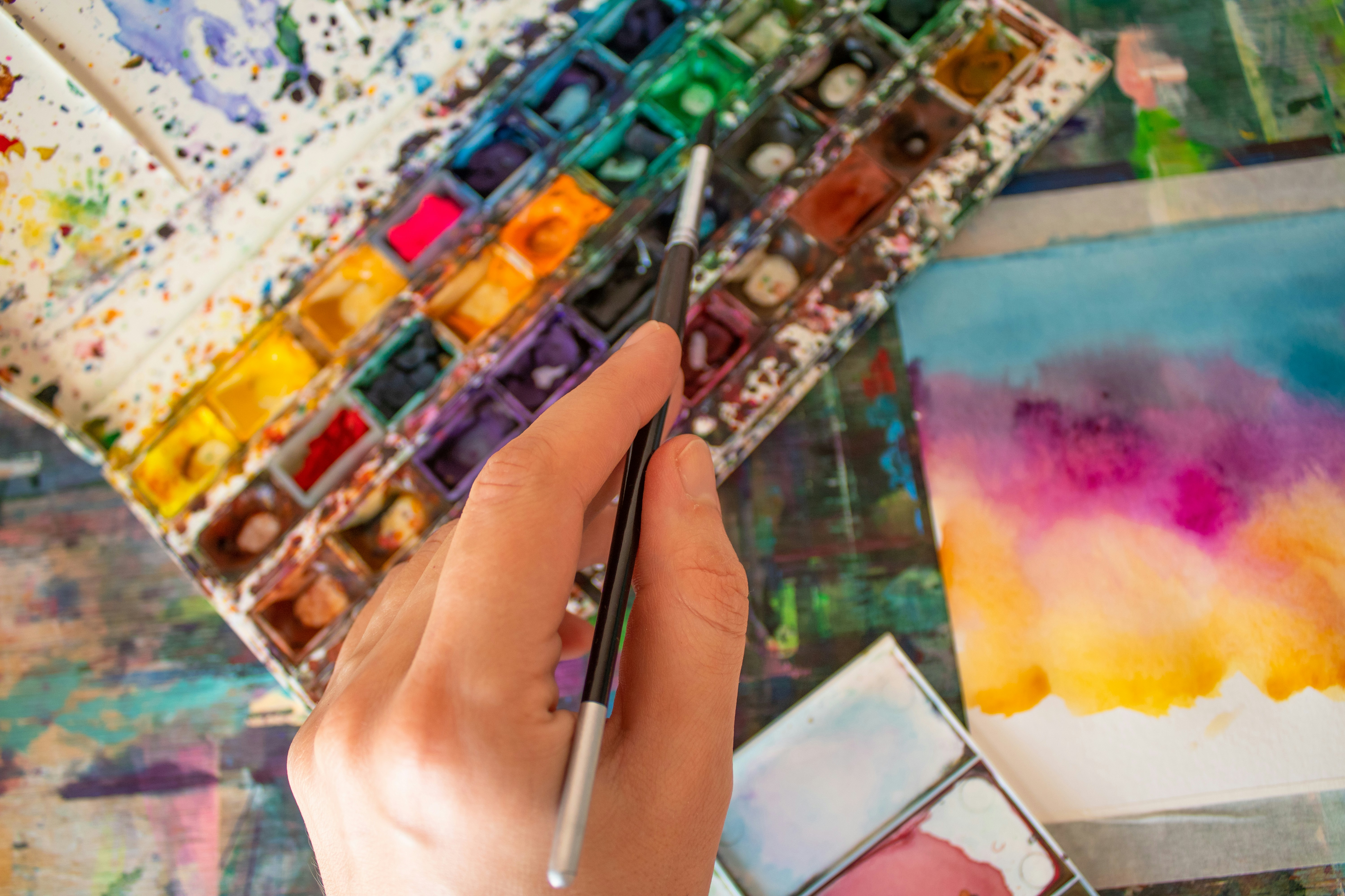 a person holding a paintbrush in their hand