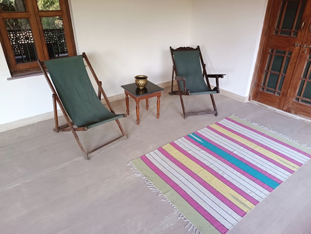 Outdoor porch space blending cozy farmhouse furniture with water views.