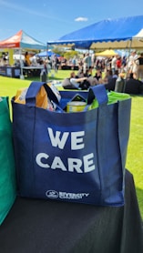 a blue tote bag sitting on top of a table
