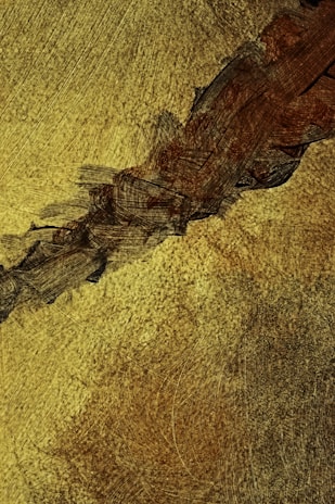 Close-up detail of fine gold lines on an abstract canvas highlighting its sophisticated texture.