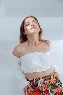 A serene morning yoga session with a woman wearing soft pastel yoga clothes, sunlight filtering through leaves.