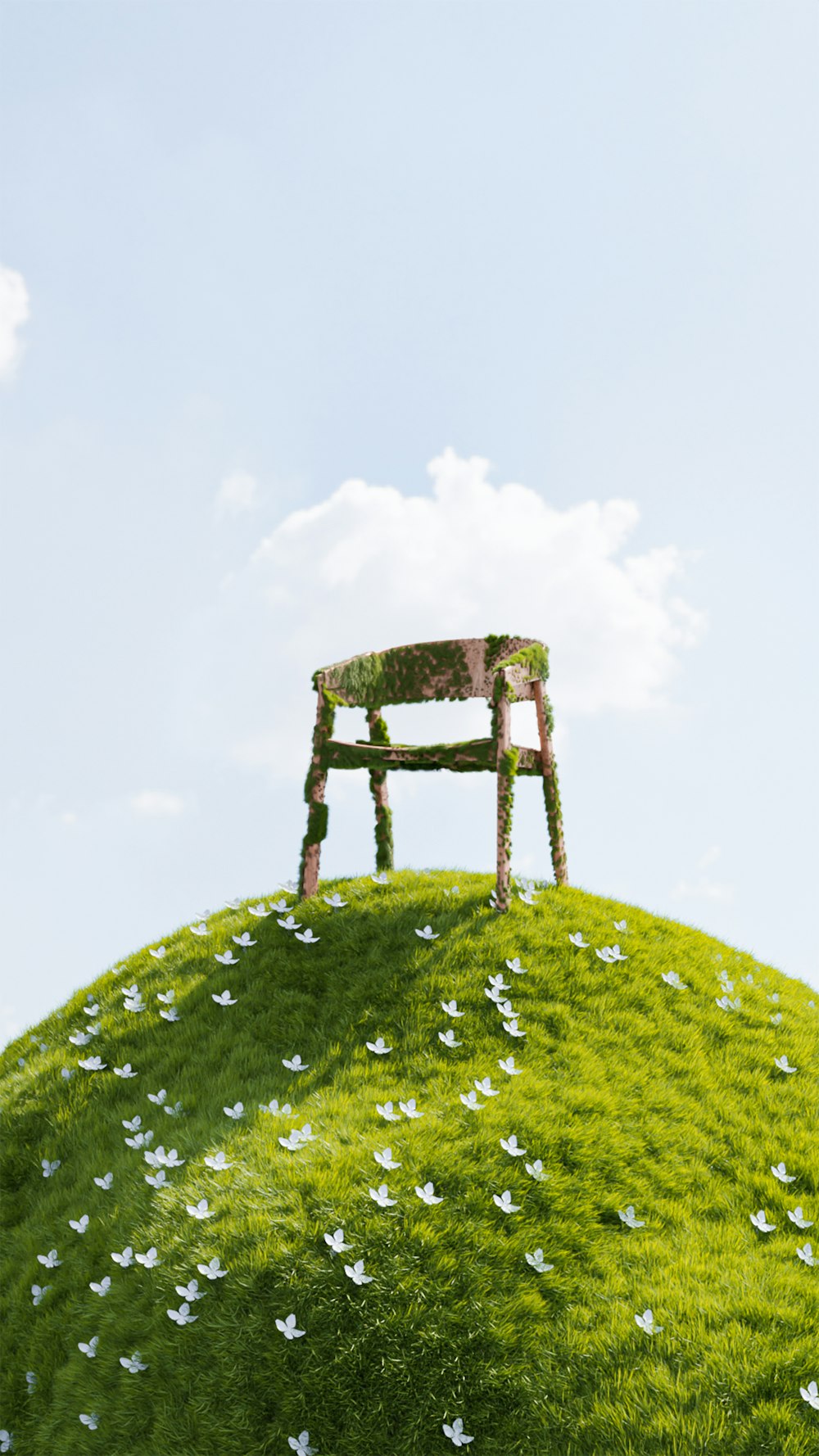 a chair sitting on top of a green hill