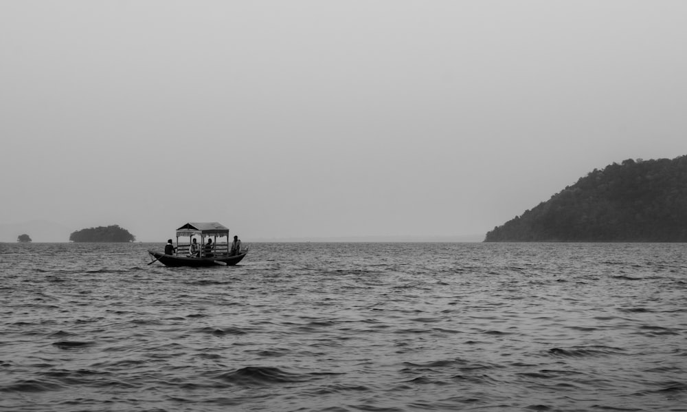 a small boat in the middle of a large body of water