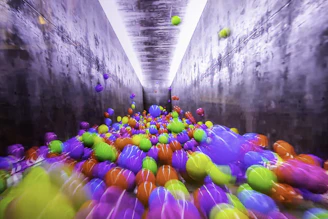 A colorful physics simulation showing bouncing balls and energy transfer.