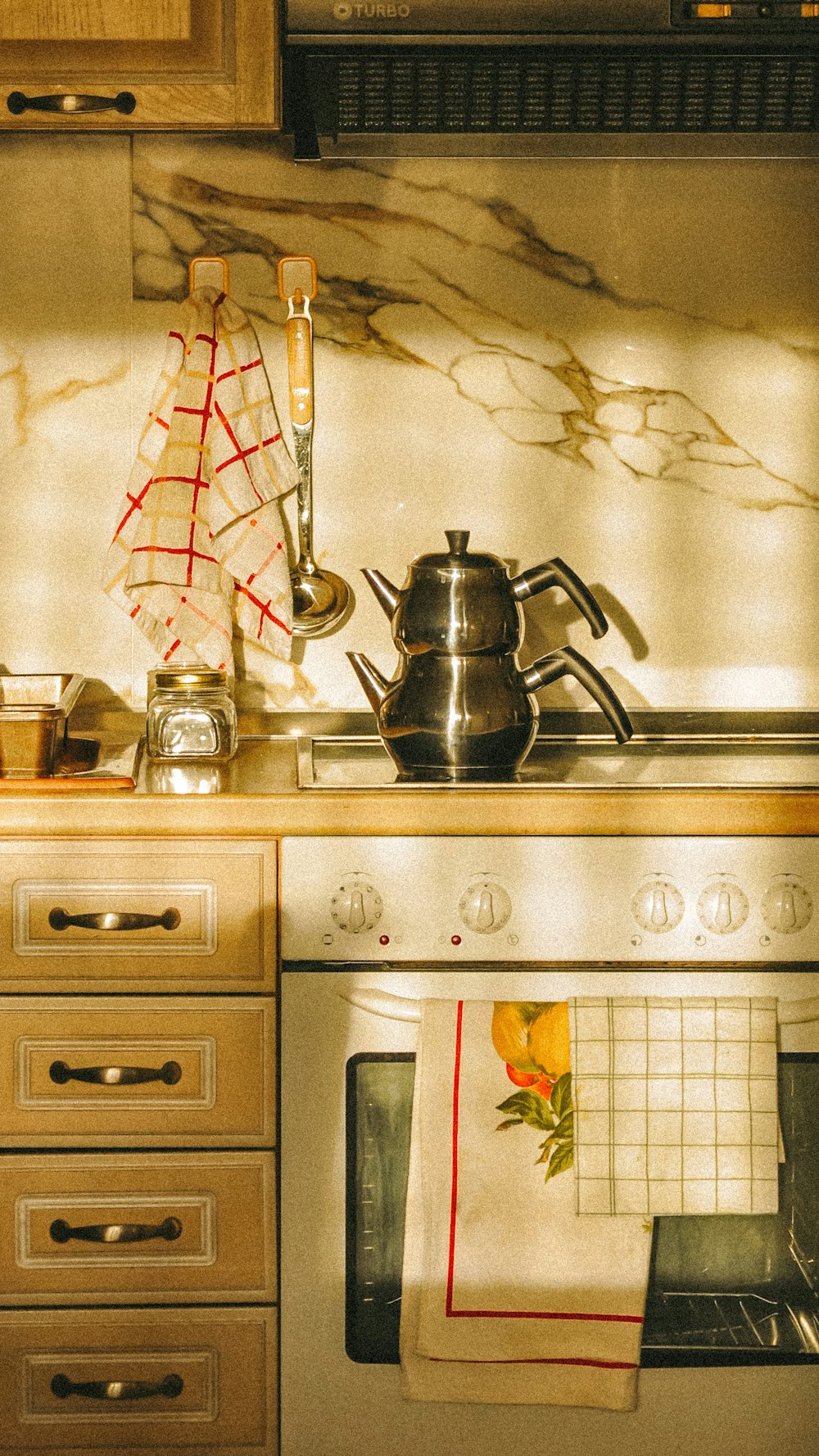 a stove top oven sitting inside of a kitchen