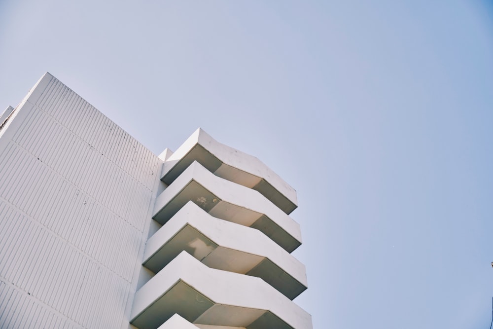 a tall white building sitting next to a tall white building