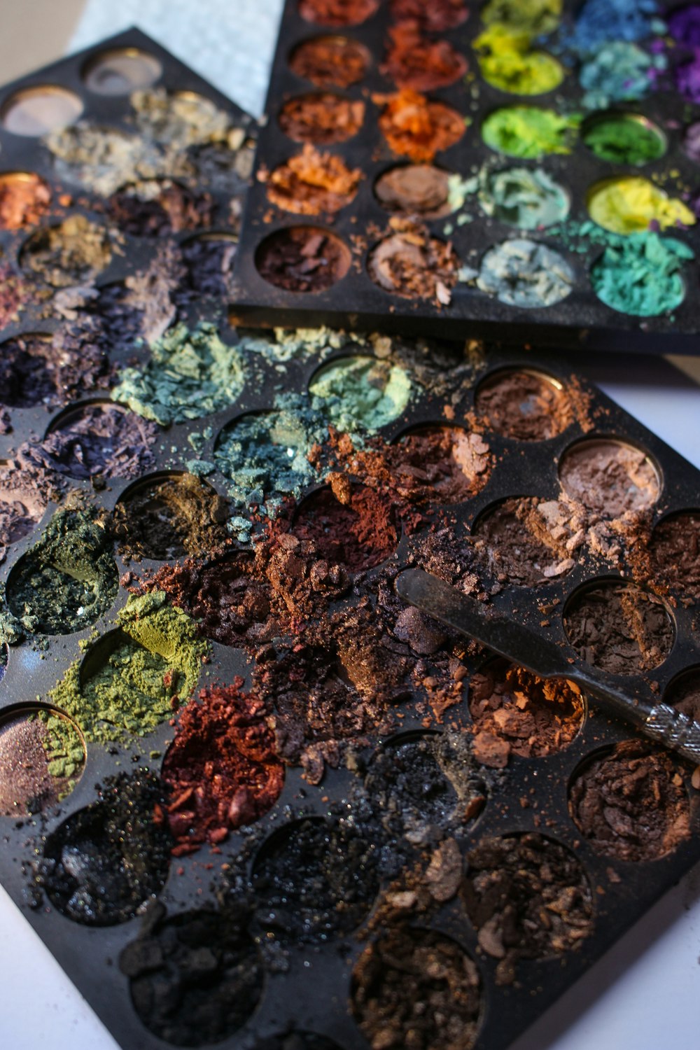 a couple of trays of paint sitting on top of a table