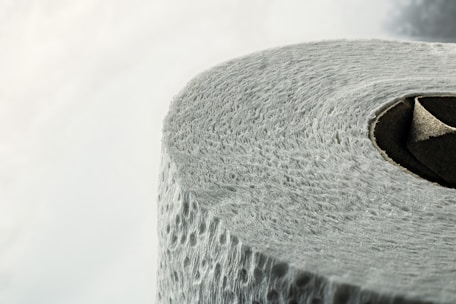 Close-up of flexible laminate rolls used in personal care packaging, highlighting texture and quality.