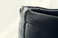 Detail of hand-painted edges on a leather belt, highlighting meticulous craftsmanship.