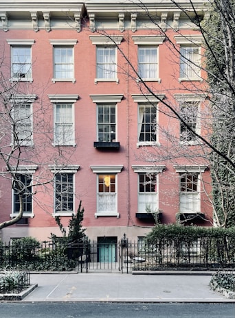 Elegant townhouse with classic brickwork and a welcoming front porch.