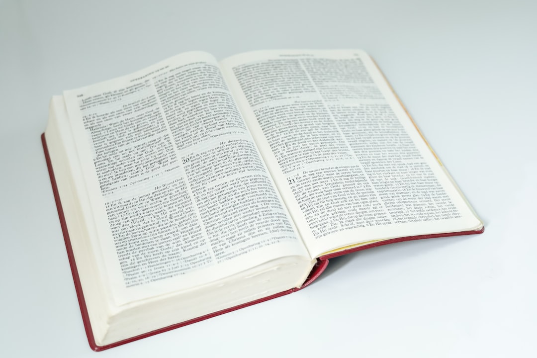 an open book sitting on top of a white table, Dutch open bible on white background.