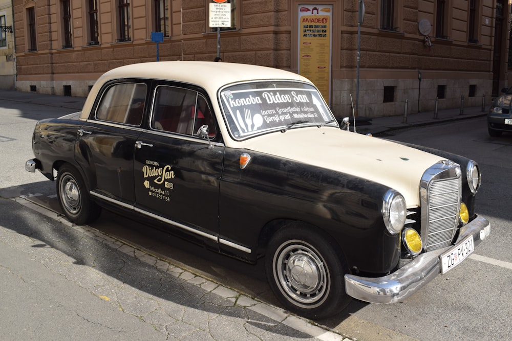 a black and white car parked on the side of the road