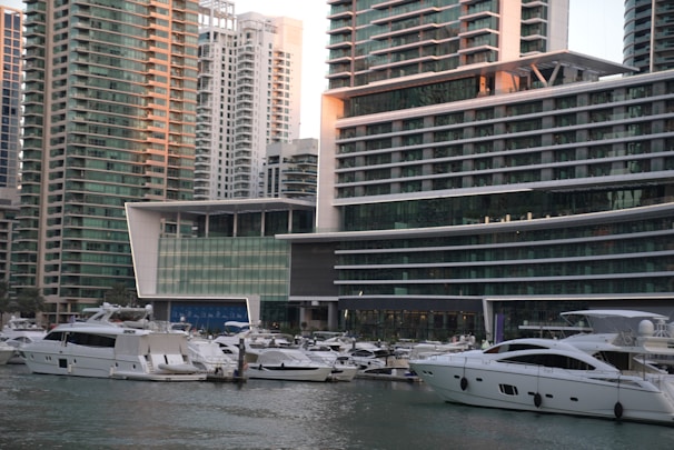 A bustling Dubai Marina waterfront with luxury yachts and upscale apartments.