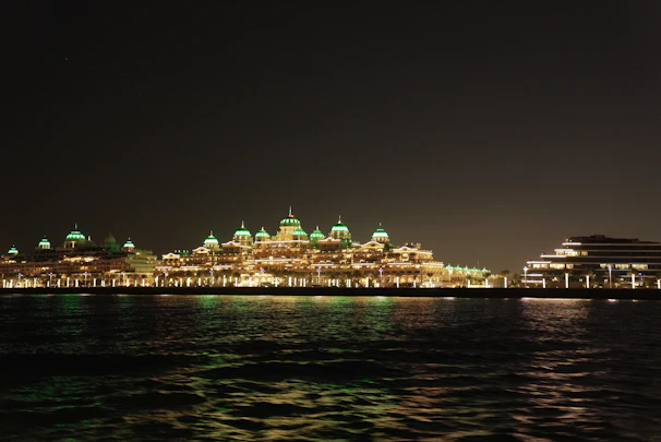 Nighttime view of the hotel illuminated softly against the dark sky.