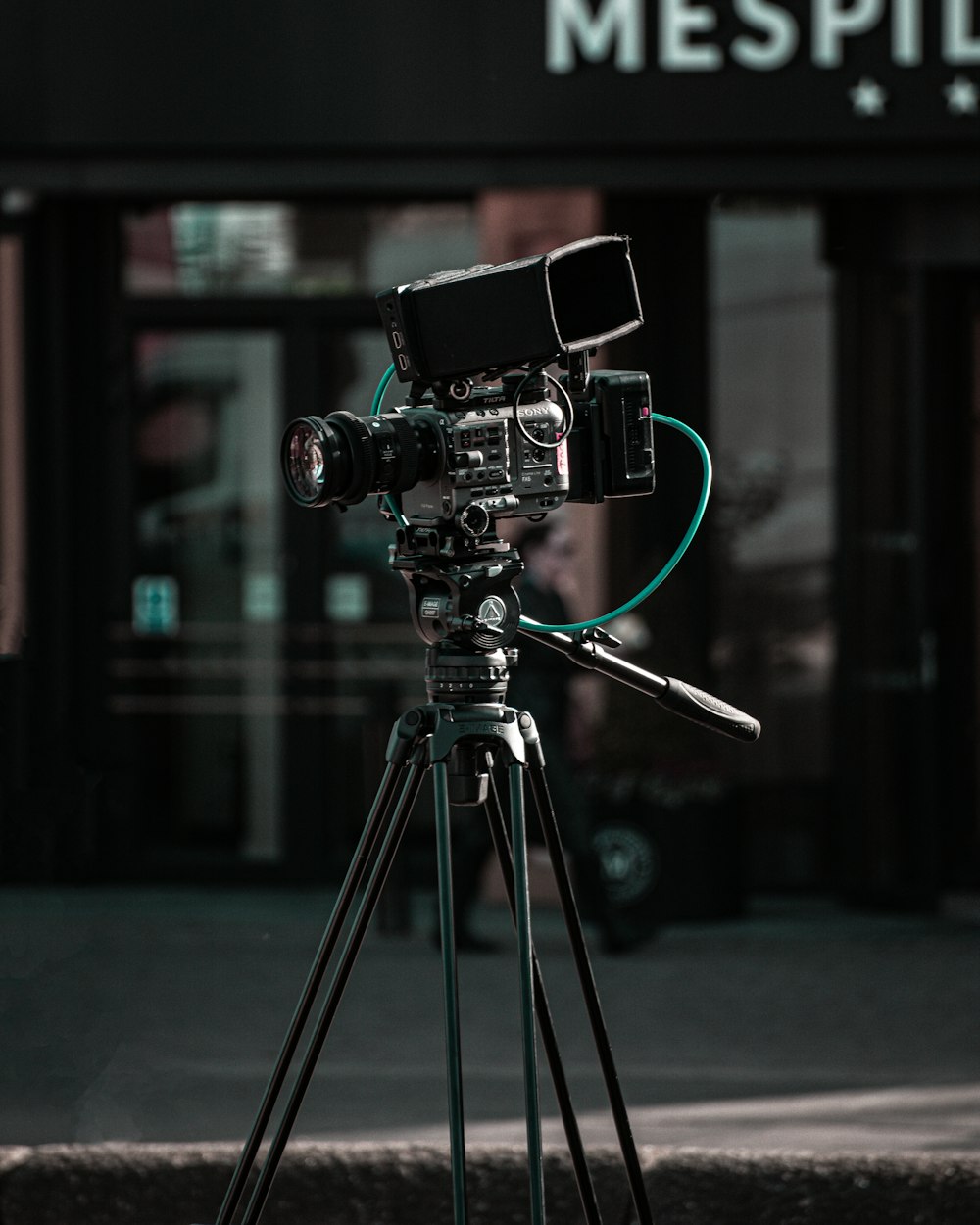 a camera on a tripod in front of a building