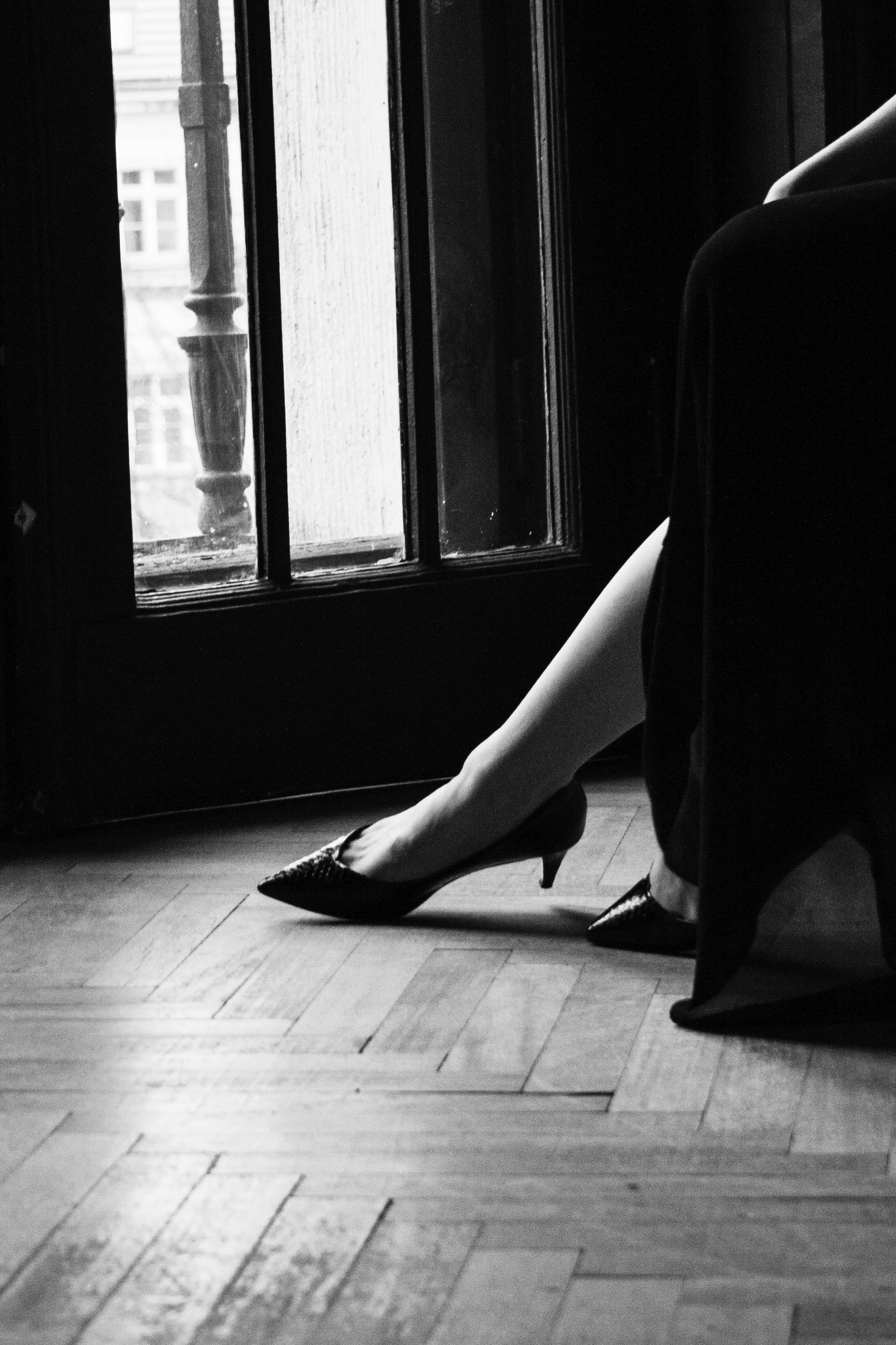 a woman in high heels sitting on the floor