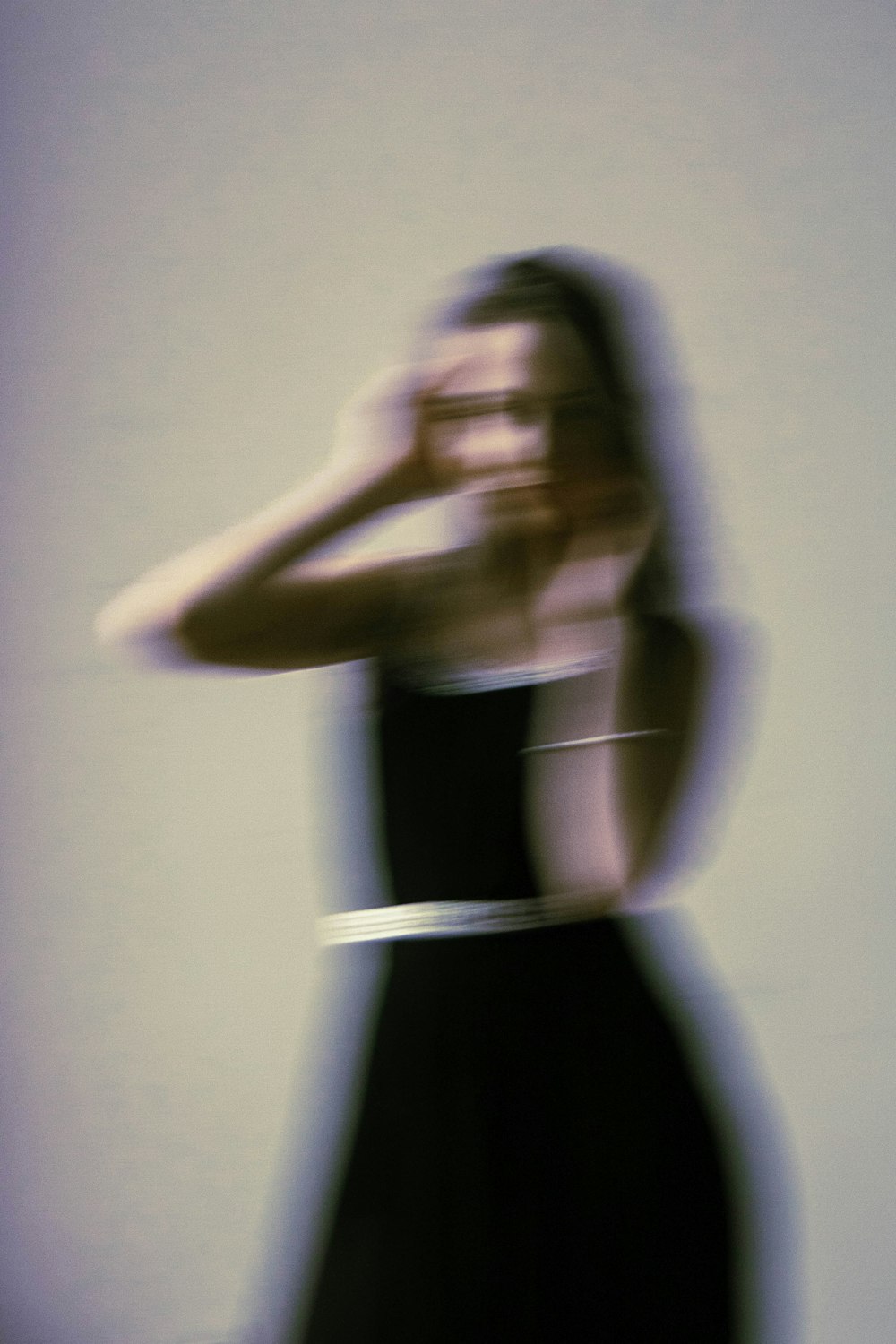 a blurry photo of a woman in a black dress