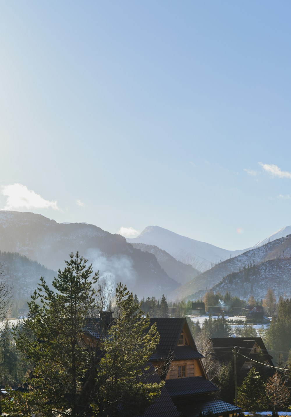 a view of a mountain range with houses in the foreground