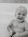 A cheerful child holding a bright, bubbly soap shaped like a star with a big smile.