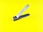 a pair of scissors sitting on top of a yellow surface