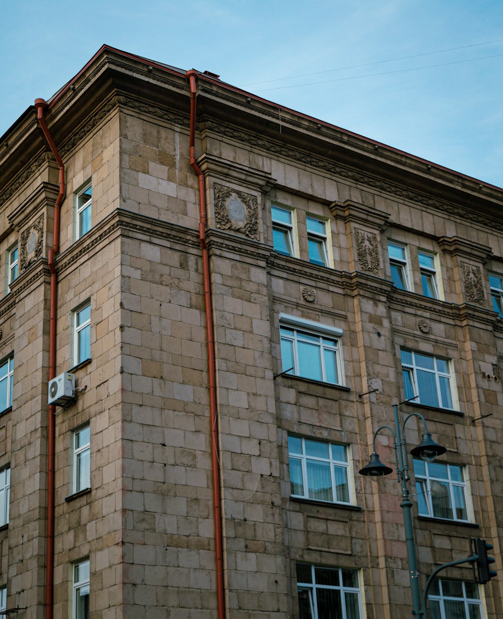 a tall brick building with a clock on the side of it