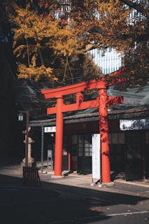 a tall red building sitting next to a tree