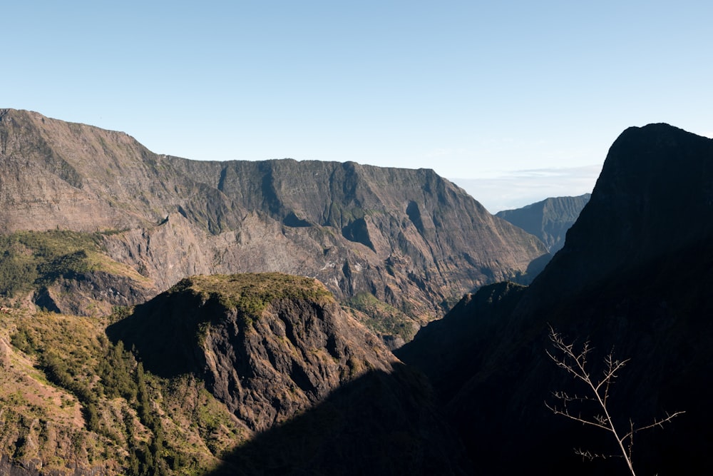 a view of a mountain range from the top of a hill