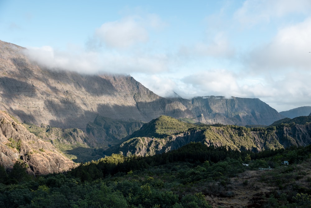 a view of a mountain range with clouds in the sky