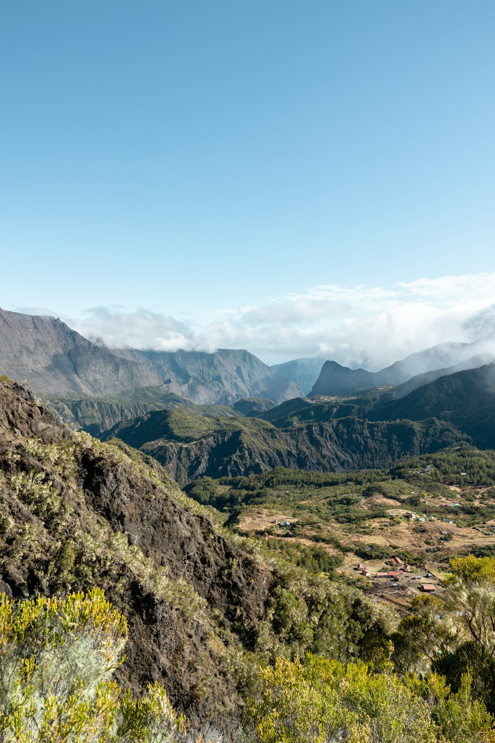 a view of a valley with mountains in the background