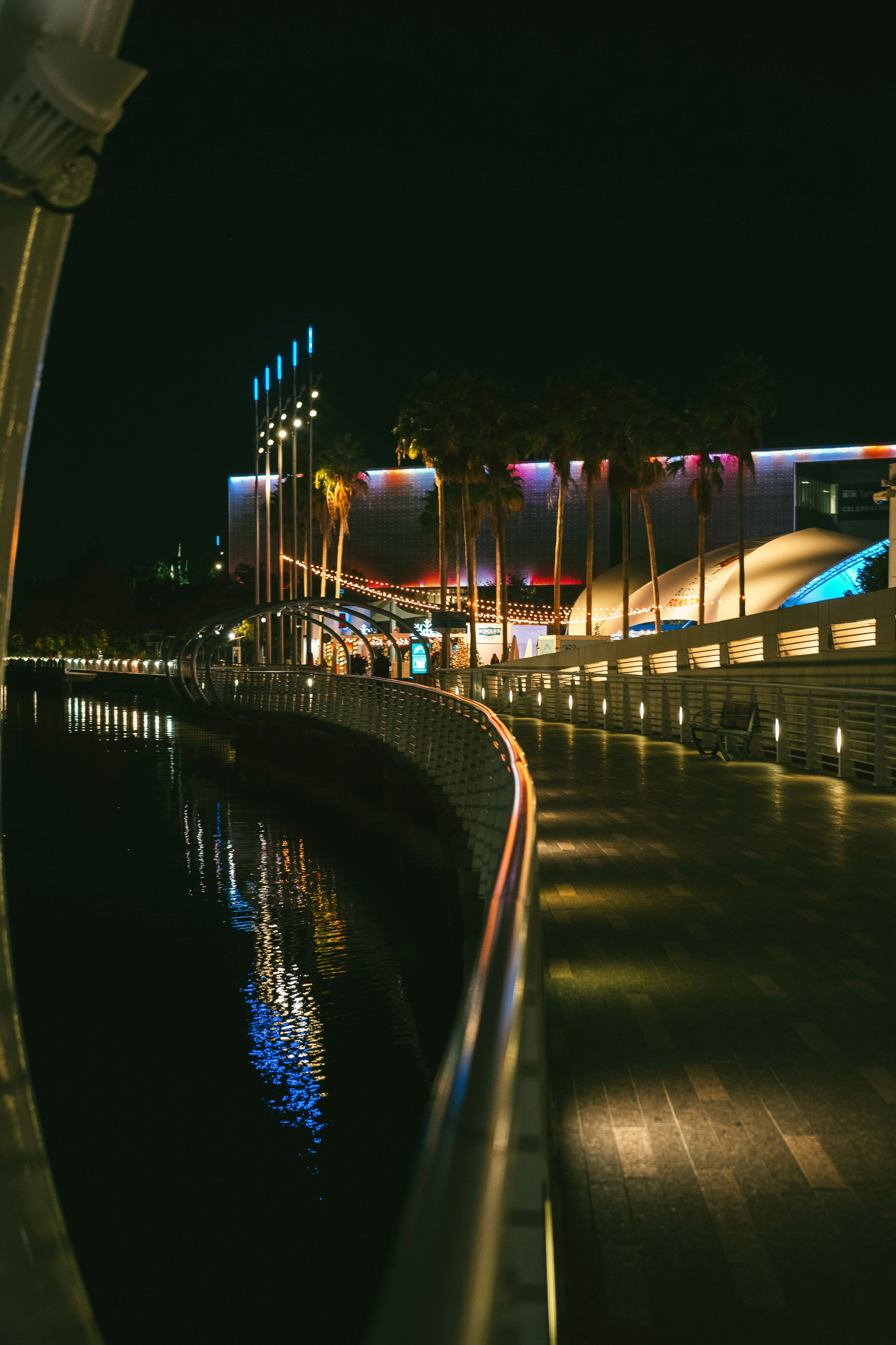 a night time view of a building and a body of water