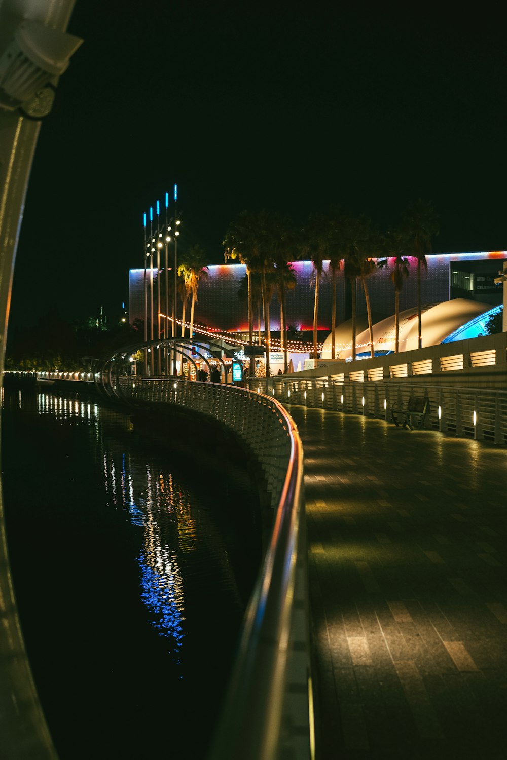 a night time view of a building and a body of water