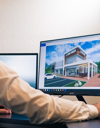 a man sitting at a desk looking at a computer screen