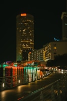 a city at night with lights reflecting in the water