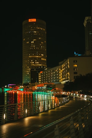 a city at night with lights reflecting in the water