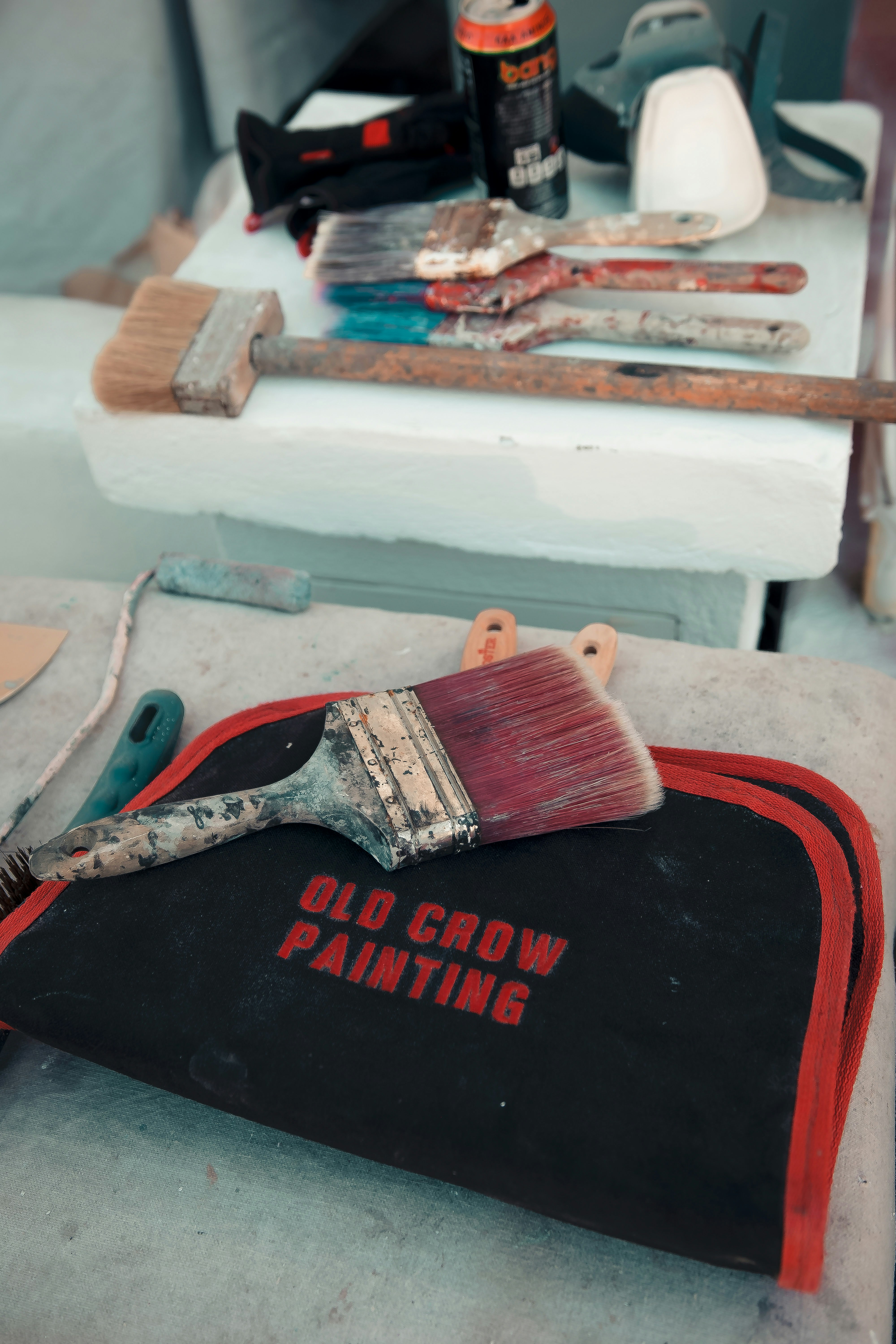 a paintbrush sitting on top of a black bag