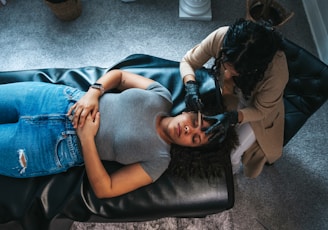a woman getting her hair done by a hair stylist