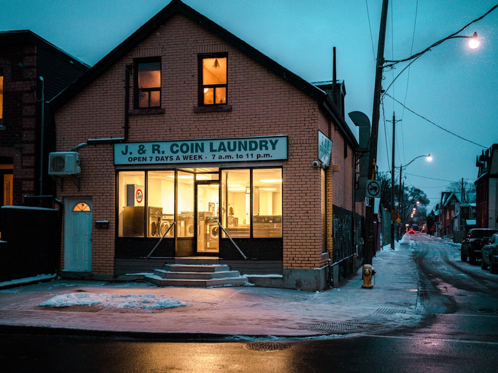 a building with a sign that reads v & b coin laundry