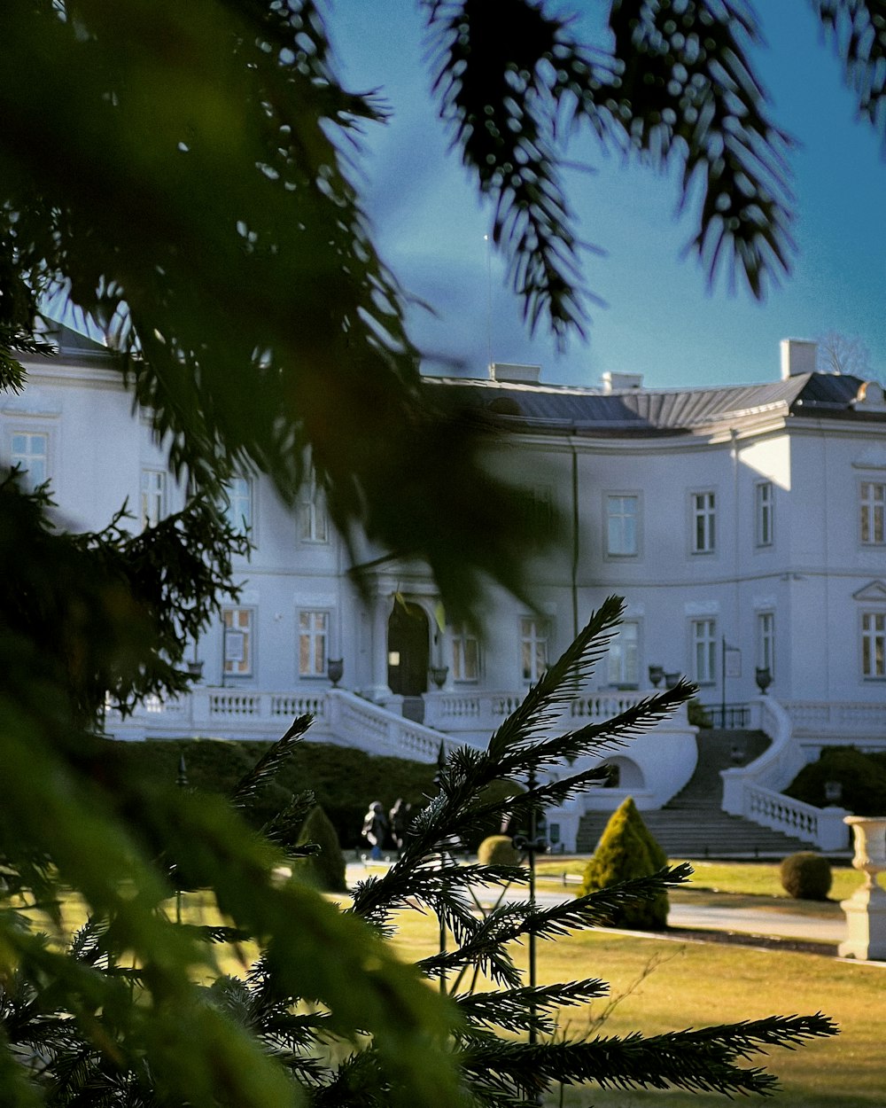 a large white building with a clock on the front of it